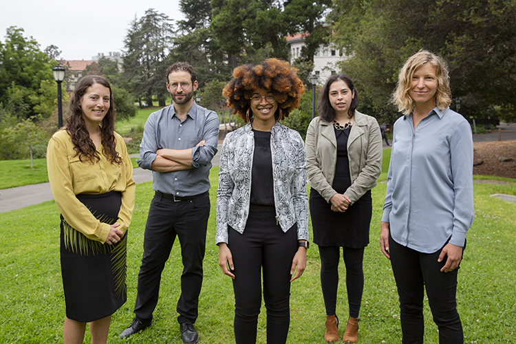A group of 5 people standing in a group outside