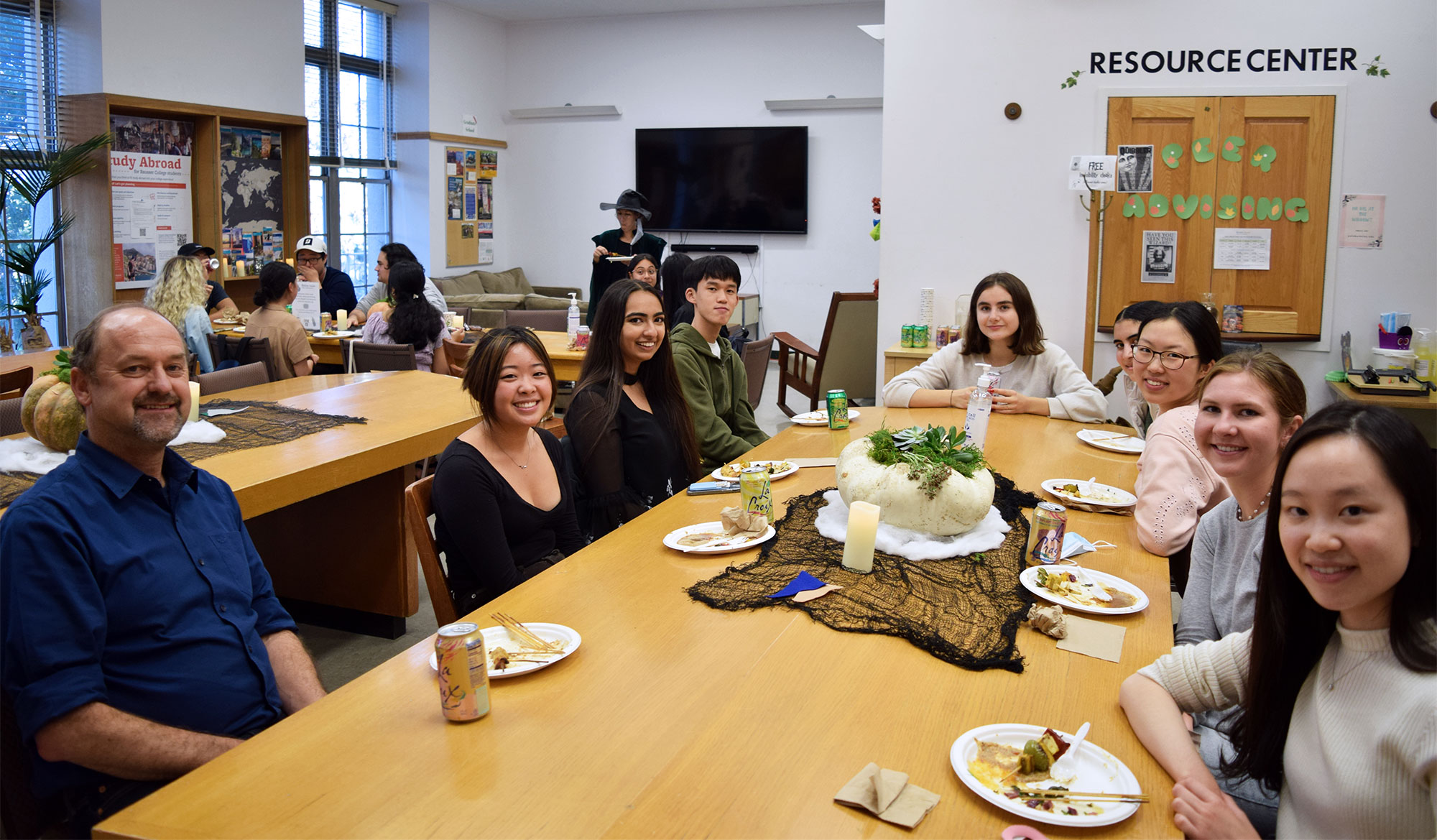 A professor and students at a dinner
