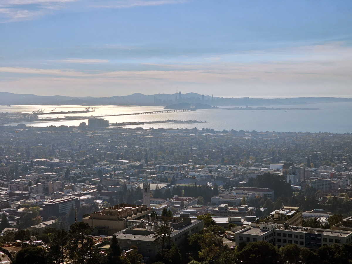 A photo of an urban and suburban landscape with a city far in the background.