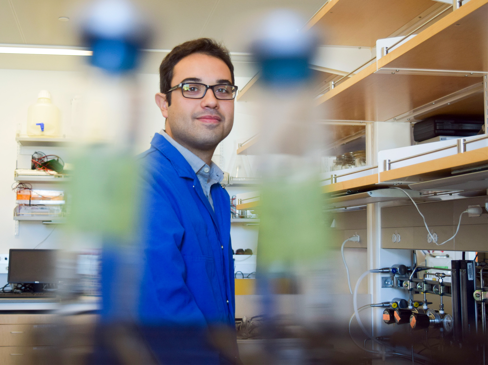 Student smiling in a lab.