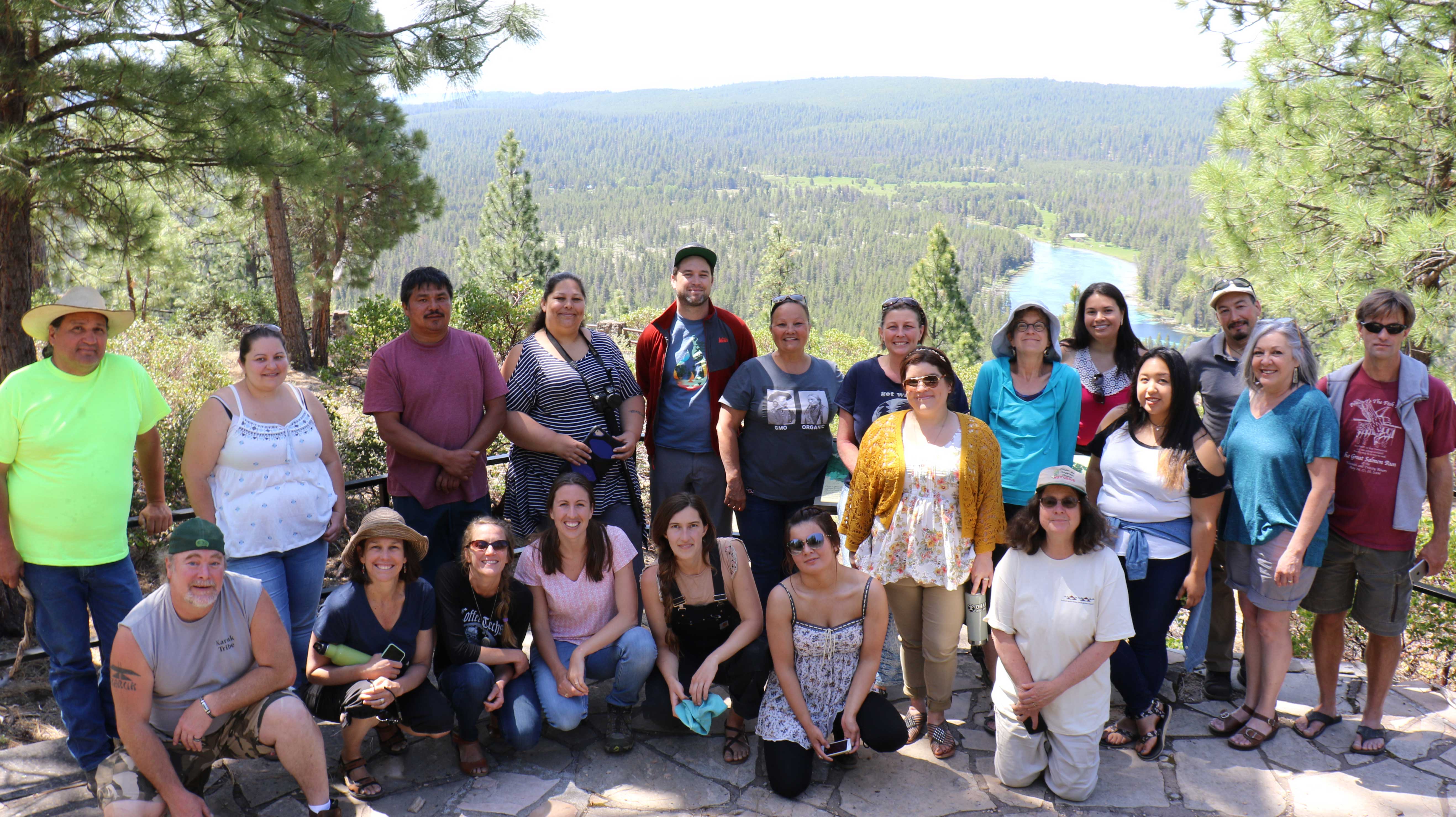 Members of the Karuk Tribe standing in front of a forest