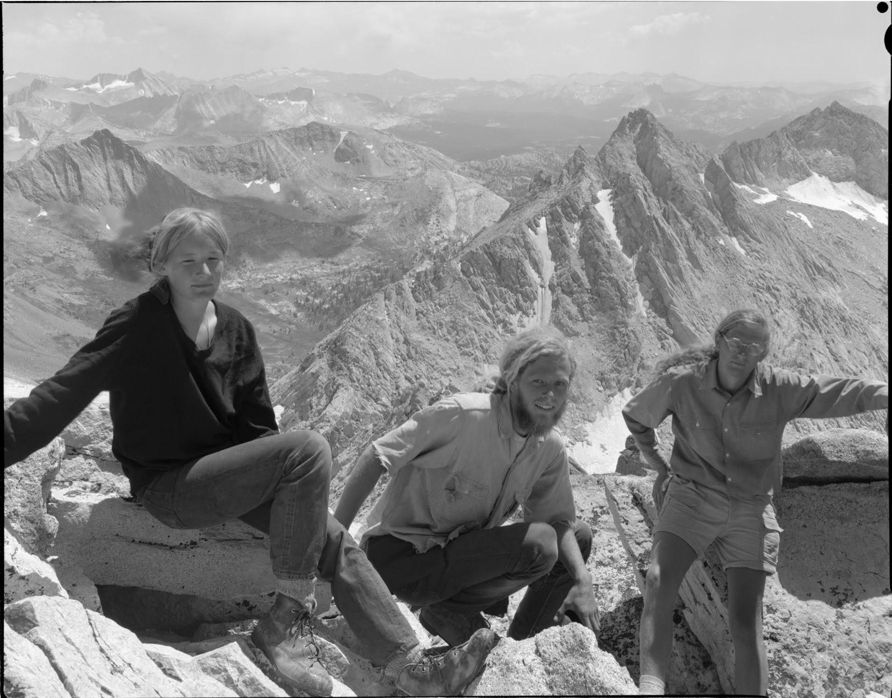 A black and white photo of three students at the top of a mountain at Yosemite National Park