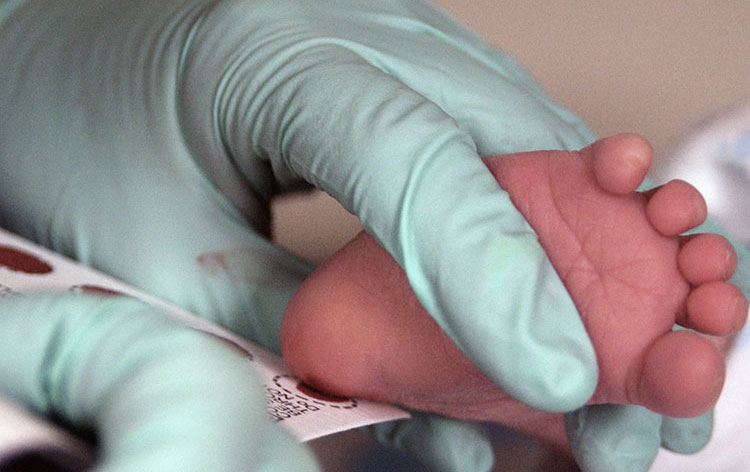 Baby foot pricked for testing.