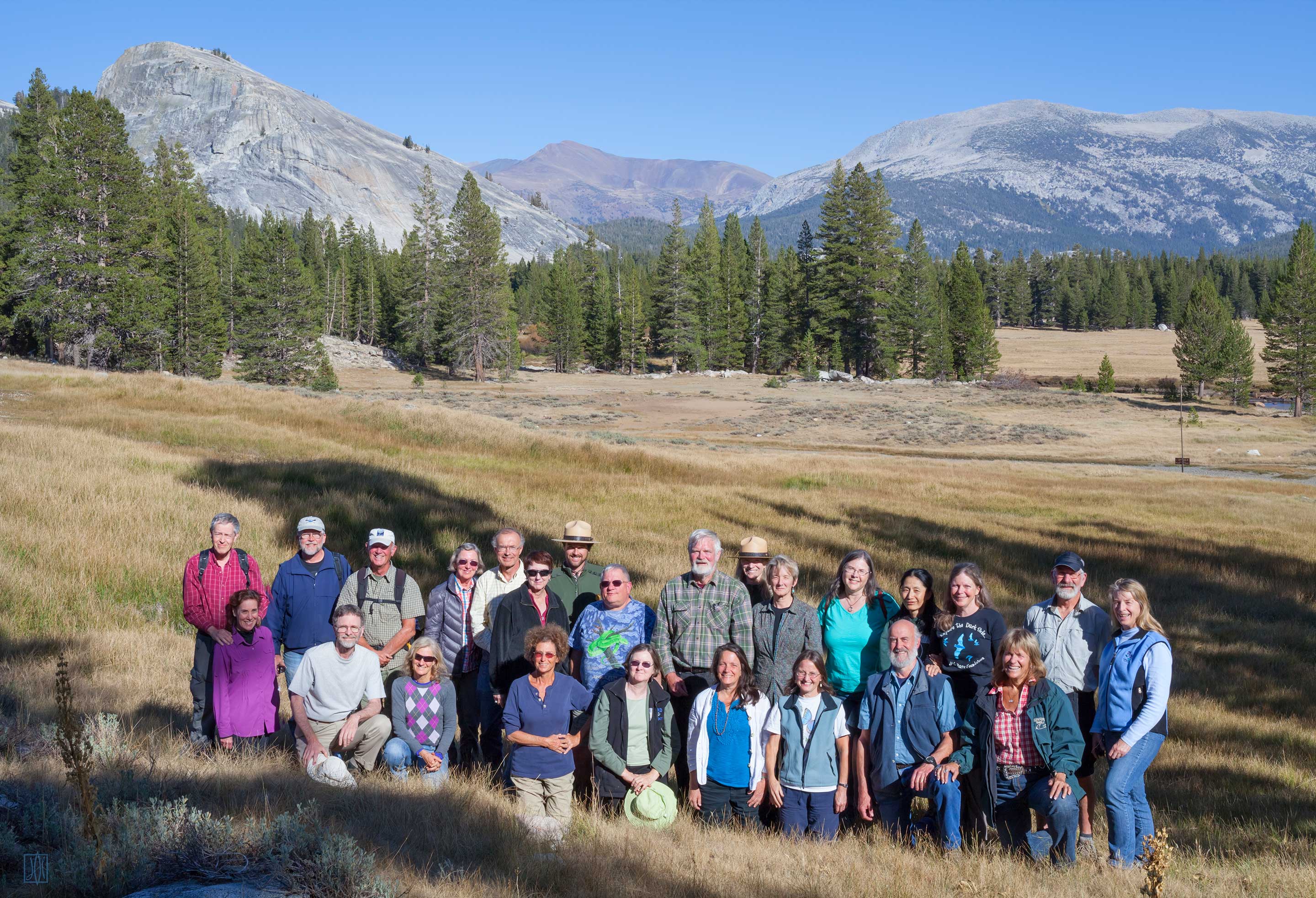 A group of people in front of a mountain