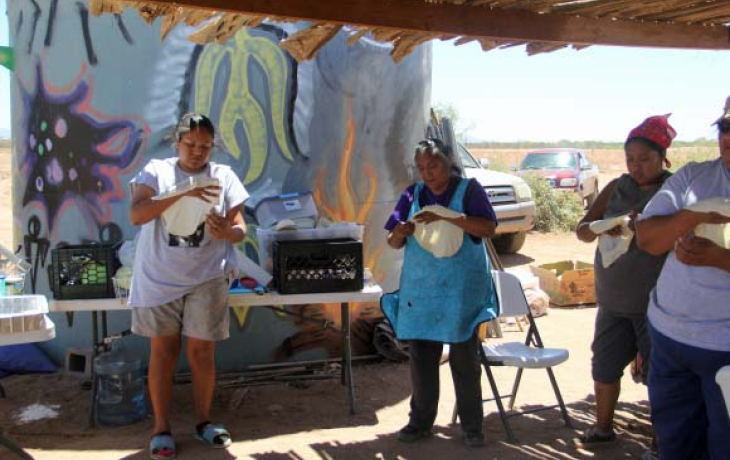 Indigenous women making bread in the desert