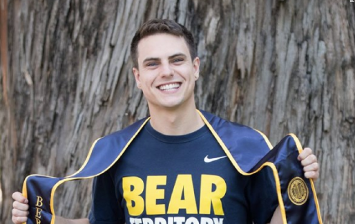 Brian wearing a "Bear Territory" shirt and his graduation stole.