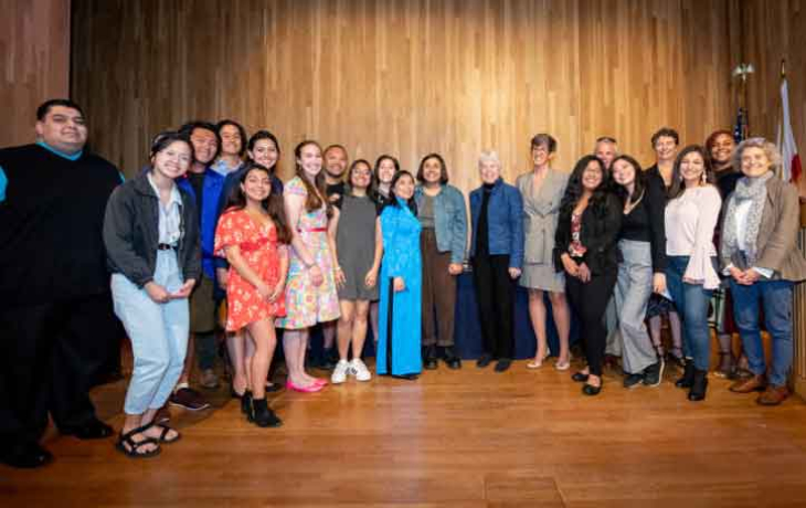 A group of students and faculty pose for a group photo