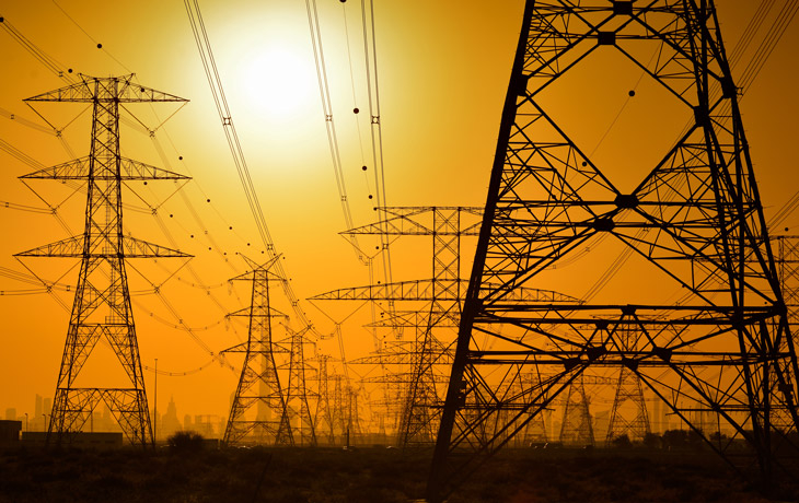 A photo of electric transmission lines at golden hour.