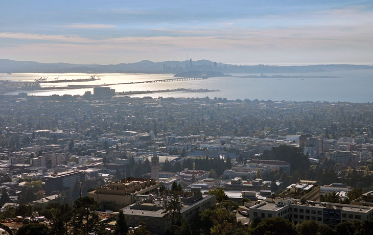 A photo of an urban and suburban landscape with a city far in the background.