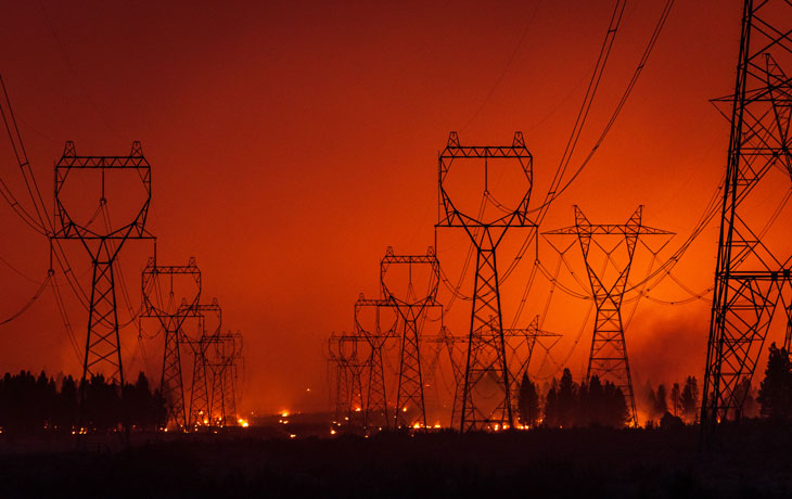 Image of a fire occurring near or within electric lines 