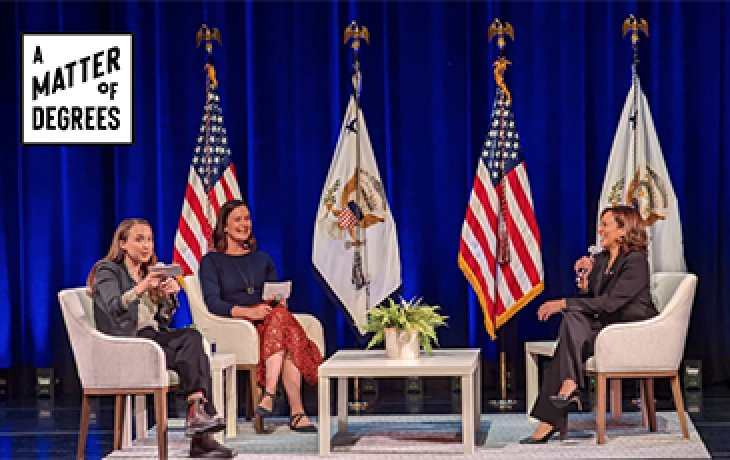 A group of people on a stage with American and California flags behind it.