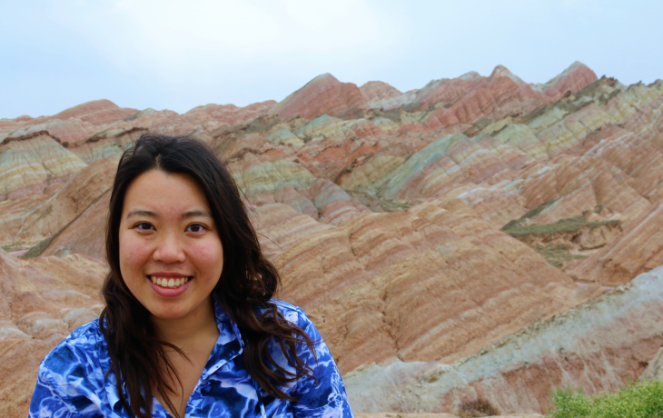 Kimberlie Le in front of a particularly colorful mountain.