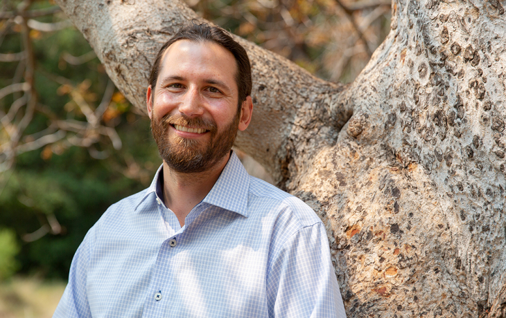 Peter Nelson standing by a tree