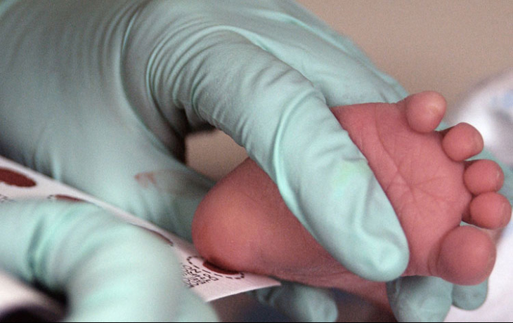 Baby foot pricked for testing.