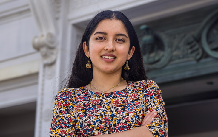 A photo of Shreya Chaudhuri standing in front of Doe Library.