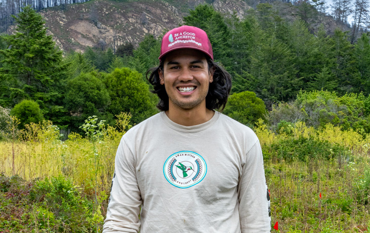 A photo of ESPM graduate student Alexii Sigona standing outdoors.