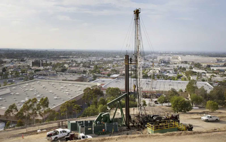 Machinery and landscape surrounding an oil well