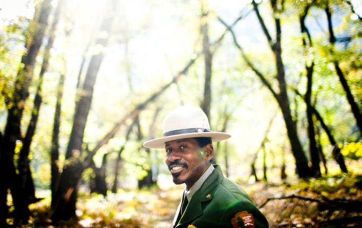 A park ranger smiles for the camera.