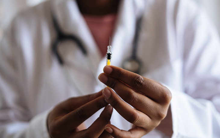 Close up of syringe in doctor's hand