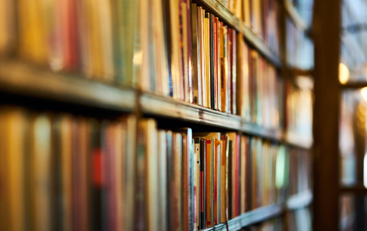 Journals and books on a library shelf