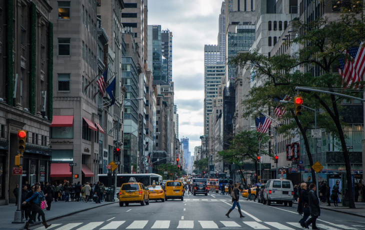 Street view of New York City with taxi cabs in background